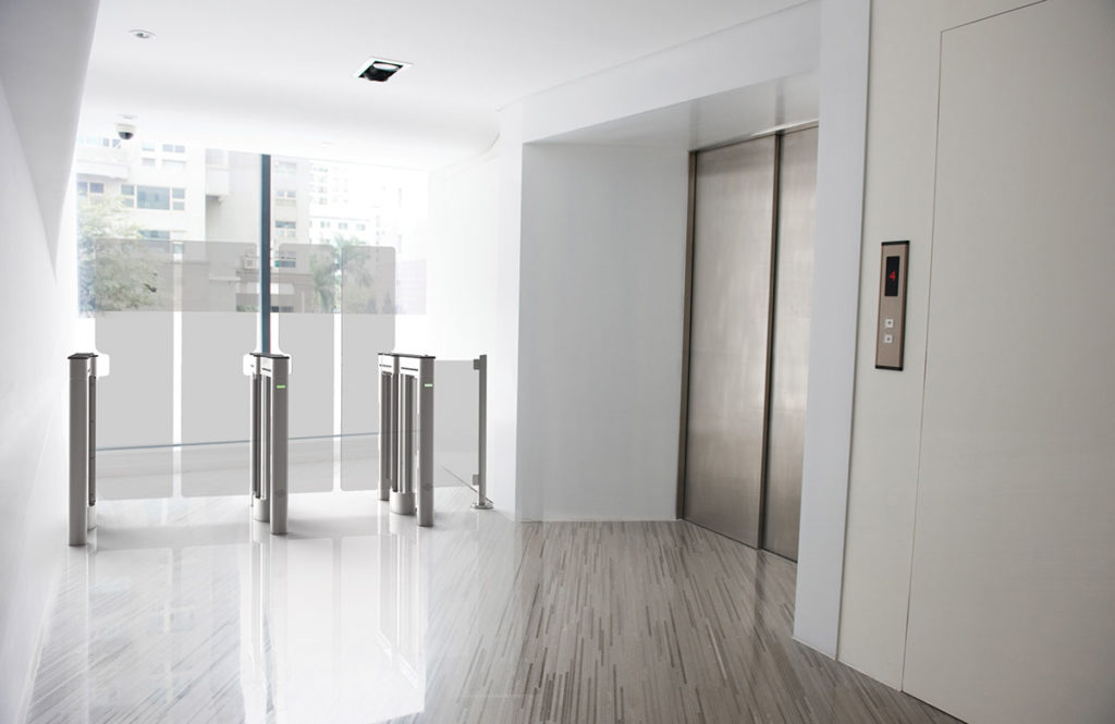 Optical Turnstiles Stand Guard In A Sunlit Elevator Lobby.