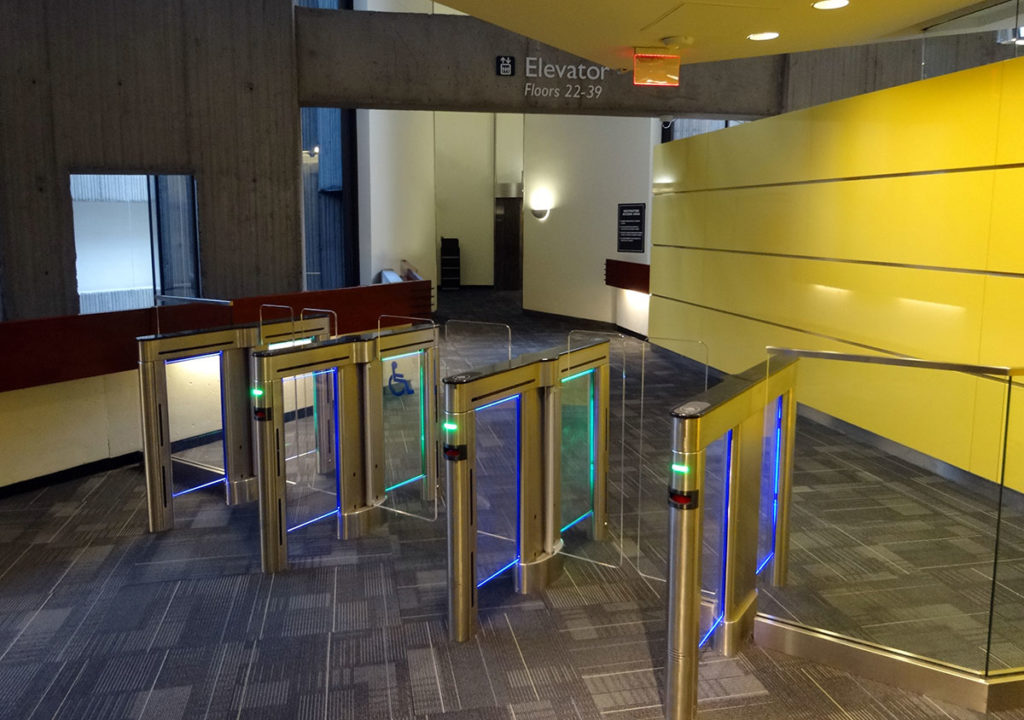 Sleek And Modern Turstiles Grace An Entrance Lobby.